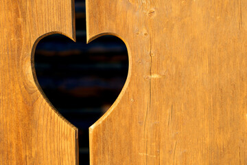 heart carved in a wooden fence