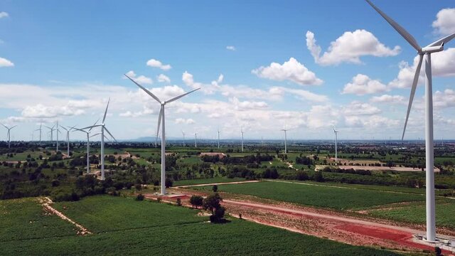 Aerial of Windmills for electric power production with white cloud and blue sky at Huai Bong, Dan Khun Thot district, Nakhon Ratchasima THAILAND. renewable energy and save  environmental concept