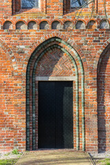 Fototapeta na wymiar Entrance to the historic Nicolai church in Appingedam, Netherlands