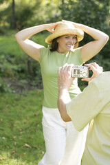 Man taking picture for his wife in the park