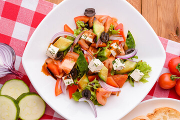 Dietary salad with vegetables, cheese feta, arugula and sauce. Traditional Italian cuisine, Italian concept.