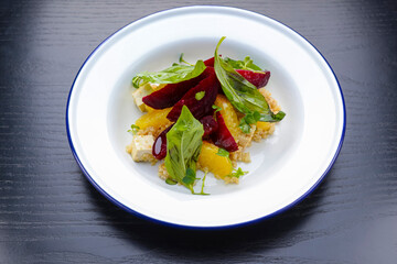 Salad with beetroot, oranges, grapefruit, radish,feta cheese and fresh greenery. Organic fruit vegetable salad.