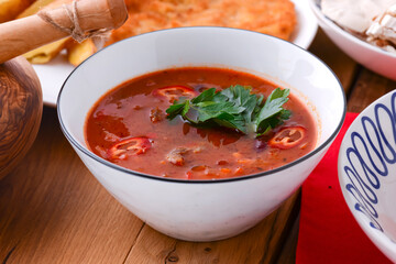 Tomato soup Gazpacho served in a white bowl over wooden background. Traditional Italian cuisine, Italian concept.