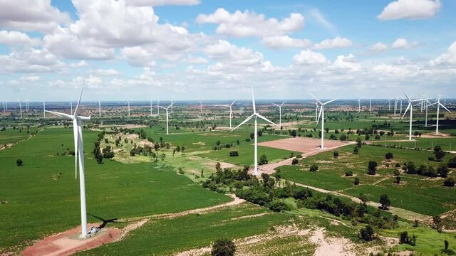 Aerial of Windmills for electric power production with white cloud and blue sky at Huai Bong, Dan Khun Thot district, Nakhon Ratchasima THAILAND. renewable energy and save  environmental concept