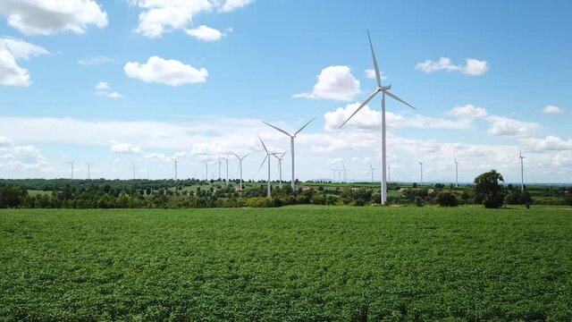 Aerial of Windmills for electric power production with white cloud and blue sky at Huai Bong, Dan Khun Thot district, Nakhon Ratchasima THAILAND. renewable energy and save  environmental concept