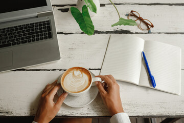 Hands business woman with laptop, glasses and cup of coffee om the table. . Female hand on laptop...