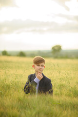 Portrait of a boy in a green wheat field.