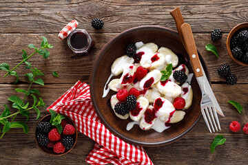 Lazy dumplings, vareniki with fresh berries. Boiled cottage cheese gnocchi with sour cream,...