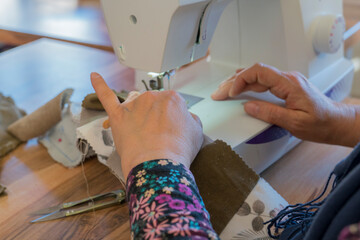 Craft education course for adults,woman sewing on the machine