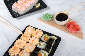 Sushi rolls set in take away boxes