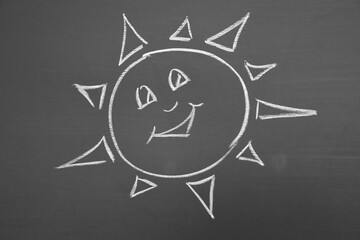 view of a sun drawn on blackboard wall