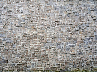 Background wall with unevenly laid out rough stone smooth