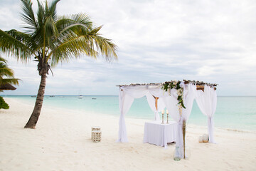 Wedding gazebo setup on the beach during summer. 