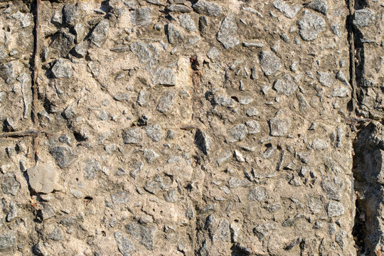 Fragment Of A Concrete Wall With A Rusty Wire Mesh
