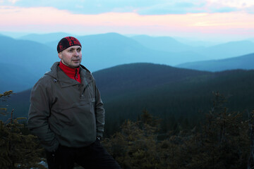 Naklejka premium Man on top of mountain. Conceptual scene.