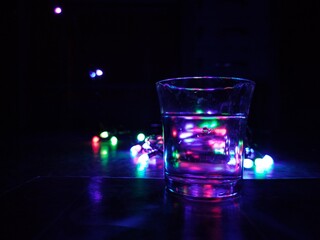A glass of vodka with a beautiful and colorful bokeh background
