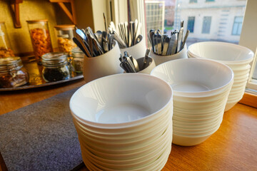 Lidkoping, Sweden July 7, 2020 Cutlery and bowls at a hotel breakfast buffe.