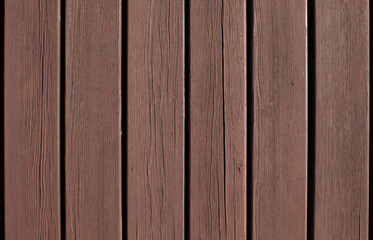 Vertical old wooden planks covered with red brownish paint peeling off