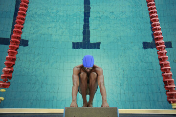 Man hanging onto the starting block