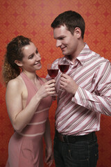 Man and woman toasting red wine