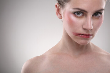 Close-up of a woman's face with make-up and smudged lipstick