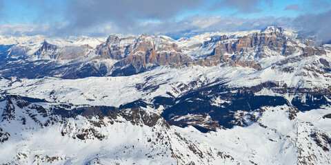 Winter panoramic landscape with mountains and clouds in the Dolomites Alps in Italy.