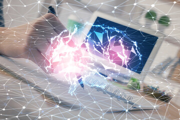 Multi exposure of writing hand on background with brain hologram. Concept of self learning.