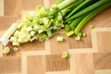 Top view of sliced fresh green onions on a cutting board for making salad. Cooking recipes concept