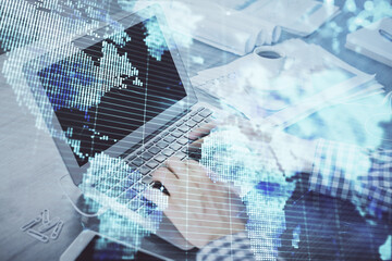 Multi exposure of businessman working on laptop on background. International business hologram in front. Concept of success.