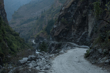 Obraz premium Dangerous curvy winding mountain road at Dharapani village over Marshyangdi river, Annapurna circuit, Nepal