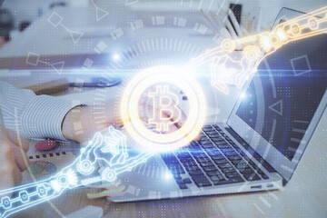 Blockchain theme hud with businessman working on computer on background. Concept of crypto chain. Double exposure.