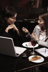 Businesswomen having discussion over dessert