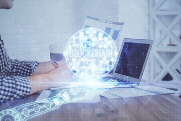 Blockchain theme hud with businessman working on computer on background. Concept of crypto chain....