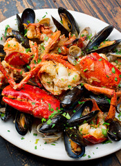 Lobster, mussels, clams and shrimp. Classic Italian restaurant entree favorite. Seafood stew baked in wood fire over and severed with olive oil, lemons and garnished with Italian parsley.