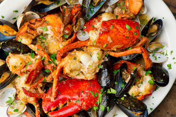 Lobster, mussels, clams and shrimp. Classic Italian restaurant entree favorite. Seafood stew baked in wood fire over and severed with olive oil, lemons and garnished with Italian parsley.