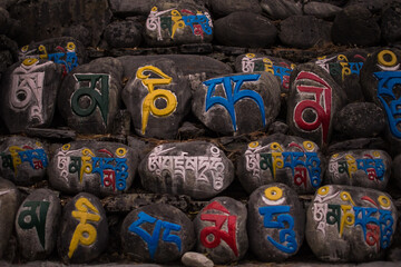 Religious colorful inscriptions in stones, Chame mountain village, Annapurna circuit, Nepal