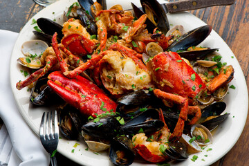 Lobster, mussels, clams and shrimp. Classic Italian restaurant entree favorite. Seafood stew baked in wood fire over and severed with olive oil, lemons and garnished with Italian parsley.