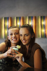 Women sharing a glass of cocktail
