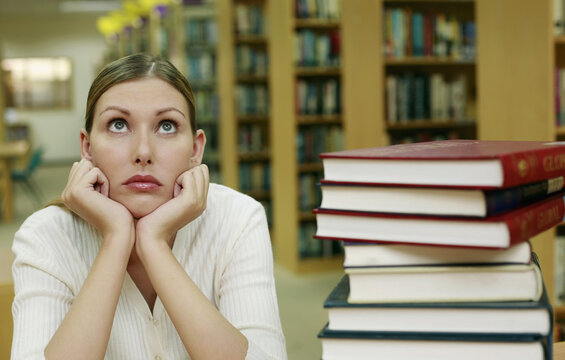 Woman staring into blank space in the library