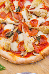 Pizza. Traditional New York City style margarita pizza pie with a thin homemade crispy crust, fresh tomato garlic marinara sauce topped with buffalo mozzarella cheese and fresh basil leaves.