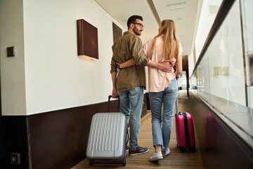 Happy young couple during trip with luggage
