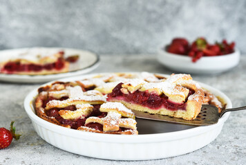 Cake with cherries and icing sugar on a concrete background. Sliced Cherry Pie.