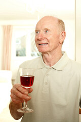 Senior man with a glass of red wine