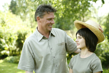 Fototapeta premium Father taking off his daughter's hat