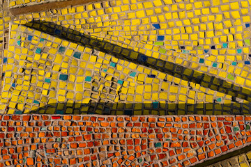 Close-up of a yellow and red mosaic design. Colourful mosaic background.