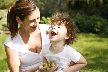 Mother and daughter picnicking in the park