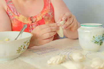 process of sculpting home-made pierogi. Grandma prepares a national Ukrainian dish - vareniki.