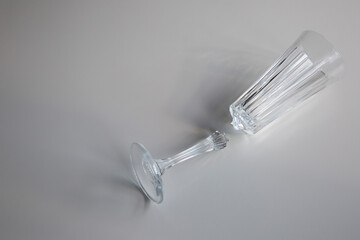 broken wine glass empty on white background, concept of collapse and ruin