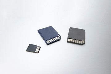 Three memory cards on gray background, selective focus. concept of memory, information storage, data storage.