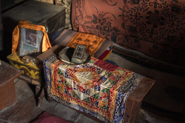 Colorful ornament mat on wooden bench, Praken Gompa, Manang village, Annapurna circuit, Nepal